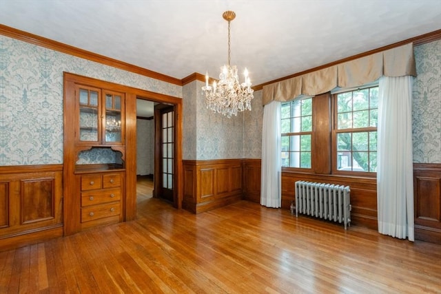 504 Mount Auburn St, Watertown, MA 02472 - unfurnished dining area with radiator, wallpapered walls, hardwood / wood-style flooring, a wainscoted wall, and a chandelier