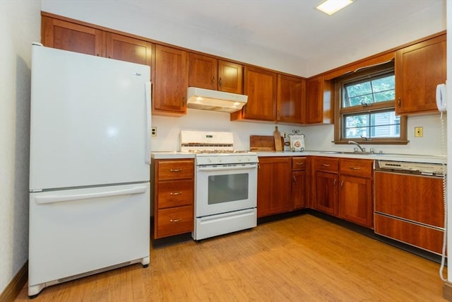 504 Mount Auburn St, Watertown, MA 02472 - kitchen featuring white appliances, under cabinet range hood, light countertops, brown cabinets, and light wood-type flooring