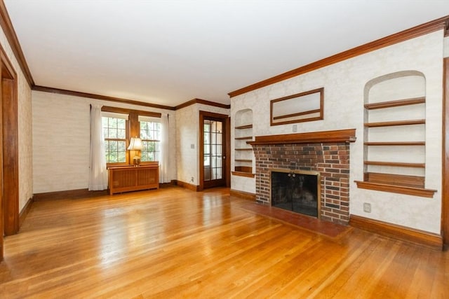 504 Mount Auburn St, Watertown, MA 02472 - unfurnished living room with light wood finished floors, built in features, a brick fireplace, and crown molding
