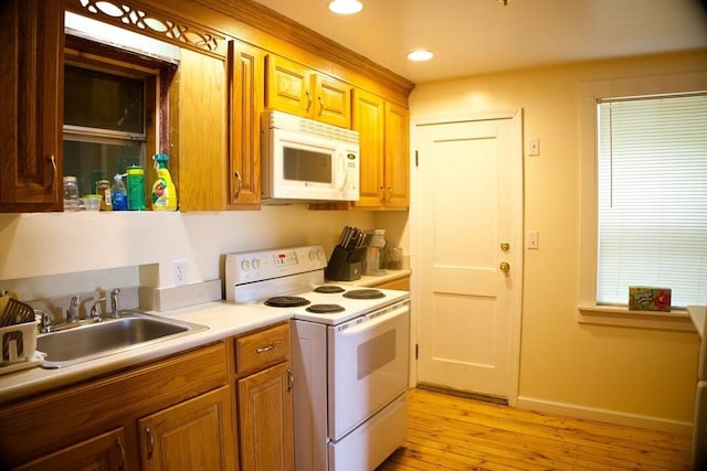 96 Harris St, Methuen, MA 01844 - kitchen featuring white appliances, light wood-style floors, recessed lighting, and light countertops
