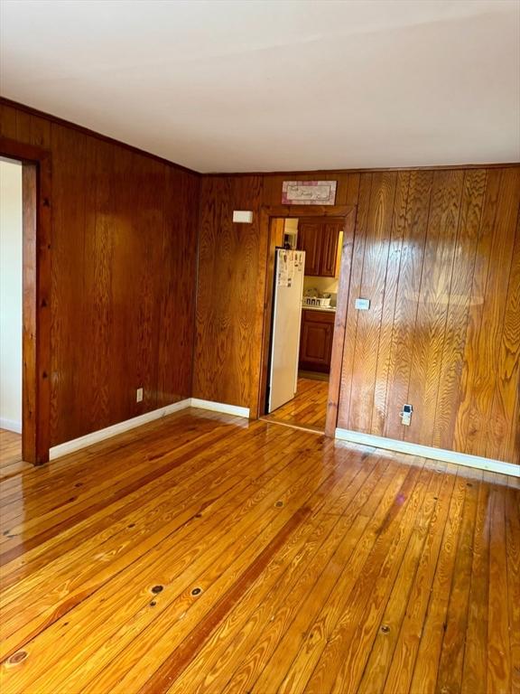 96 Harris St, Methuen, MA 01844 - spare room with hardwood / wood-style flooring and wood walls