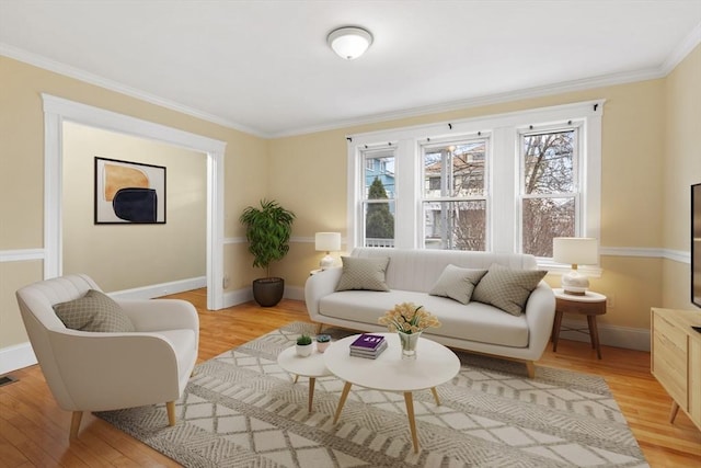 sitting room featuring light hardwood / wood-style floors and crown molding