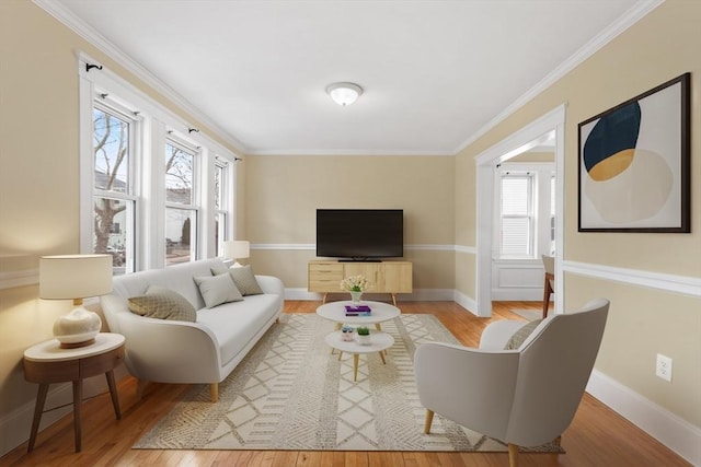 living room with light hardwood / wood-style floors and ornamental molding