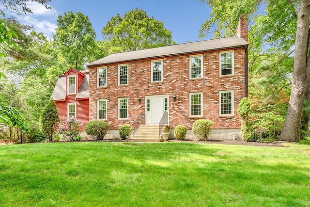 31 Alexander Rd, Hopkinton, MA 01748 - colonial home with a chimney, a front yard, entry steps, and brick siding