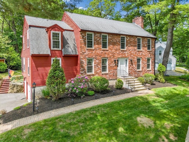 31 Alexander Rd, Hopkinton, MA 01748 - view of front facade featuring a chimney, a shingled roof, a front lawn, asphalt driveway, and an attached garage
