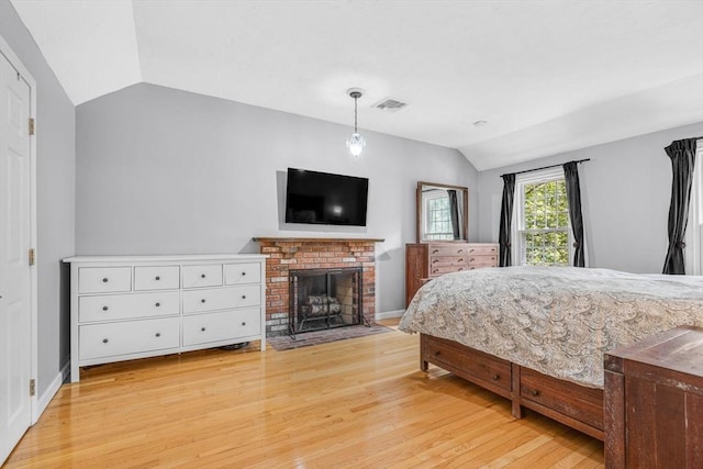 31 Alexander Rd, Hopkinton, MA 01748 - bedroom with vaulted ceiling, light wood-type flooring, a fireplace, and baseboards