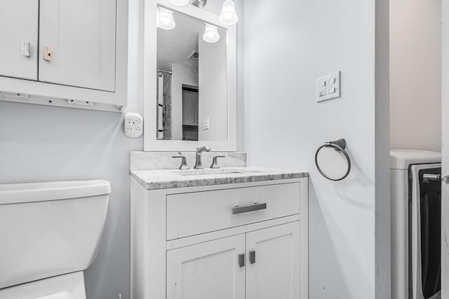 31 Alexander Rd, Hopkinton, MA 01748 - bathroom featuring washer / clothes dryer, toilet, and vanity