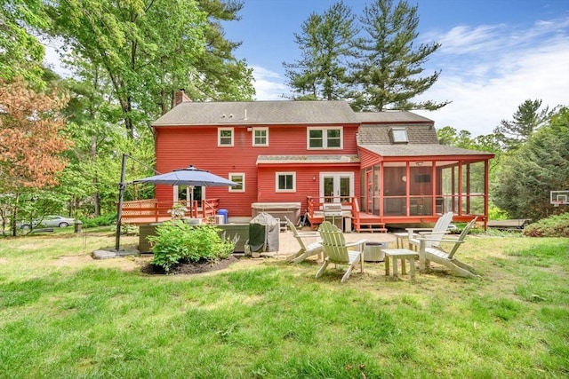 31 Alexander Rd, Hopkinton, MA 01748 - rear view of property with a sunroom, a deck, a chimney, and a yard