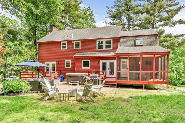 31 Alexander Rd, Hopkinton, MA 01748 - back of property with a hot tub, a chimney, a wooden deck, a shingled roof, and a yard