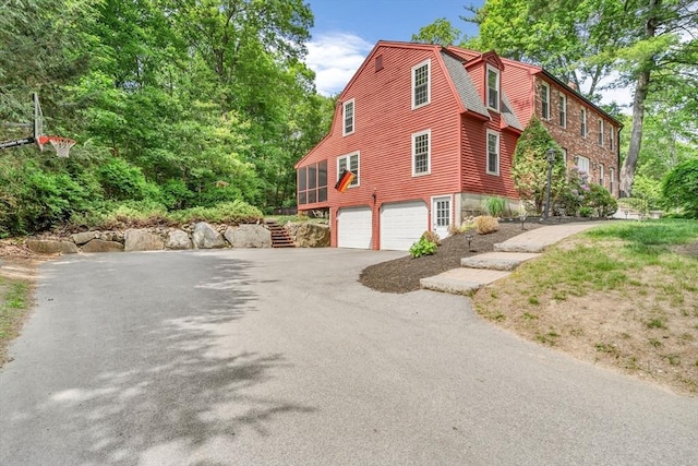 31 Alexander Rd, Hopkinton, MA 01748 - view of property exterior featuring driveway, stairs, a garage, and a gambrel roof