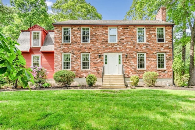 31 Alexander Rd, Hopkinton, MA 01748 - colonial inspired home featuring entry steps, a chimney, a front yard, and brick siding