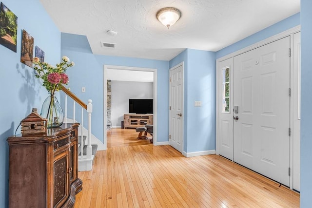 31 Alexander Rd, Hopkinton, MA 01748 - foyer entrance with light wood-style flooring, stairs, and baseboards