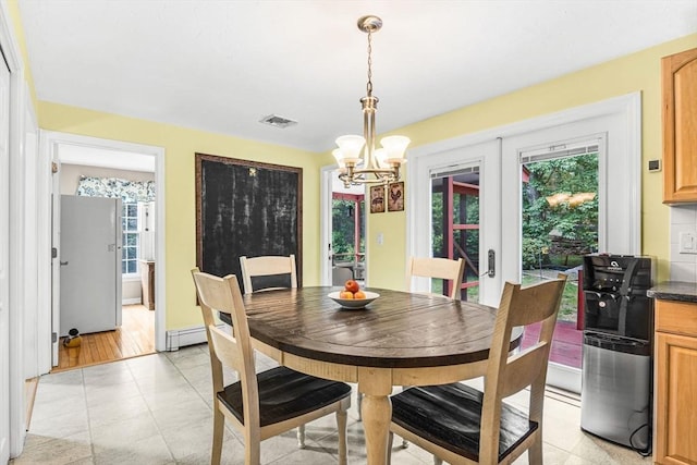 31 Alexander Rd, Hopkinton, MA 01748 - dining area featuring a chandelier, plenty of natural light, french doors, and a baseboard radiator