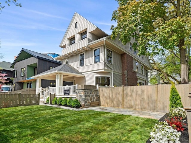 rear view of house featuring covered porch