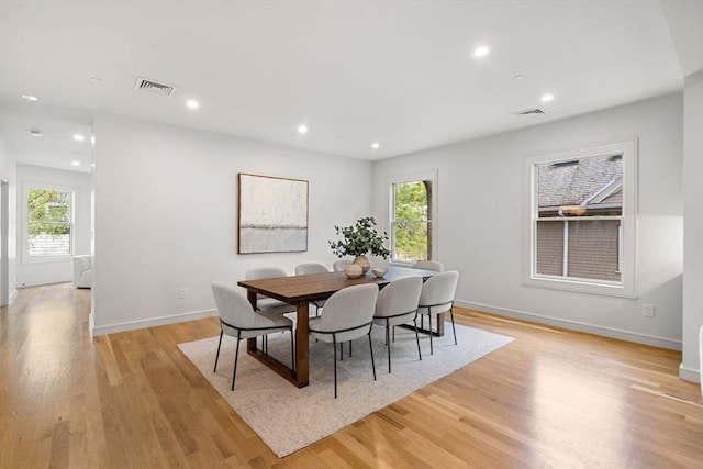 dining space featuring light wood-style flooring, baseboards, and recessed lighting