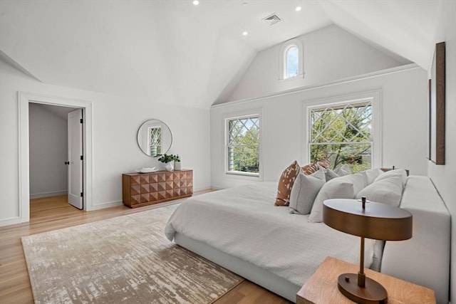 bedroom featuring light wood-type flooring, lofted ceiling, baseboards, and recessed lighting