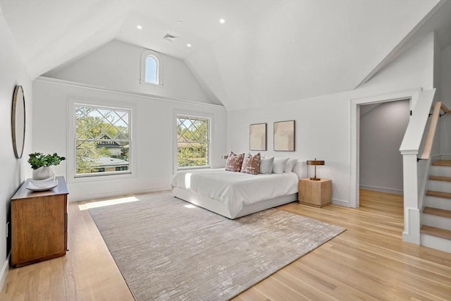 bedroom featuring light wood-style floors, recessed lighting, baseboards, and high vaulted ceiling