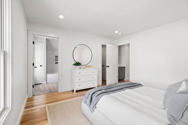 bedroom featuring wood finished floors, recessed lighting, and baseboards