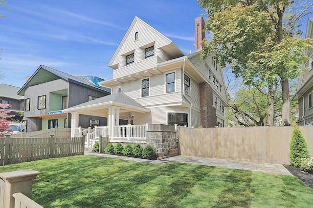 traditional style home with covered porch and a chimney
