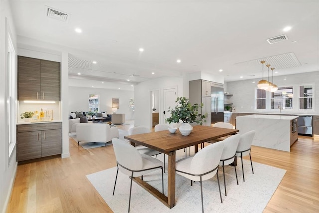 dining area featuring light wood finished floors and recessed lighting