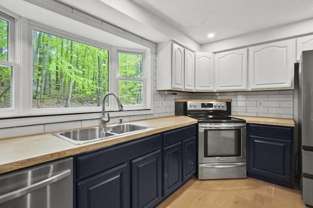 455 Main St, Rutland, MA 01543 - kitchen with butcher block counters, stainless steel appliances, a sink, white cabinetry, and recessed lighting
