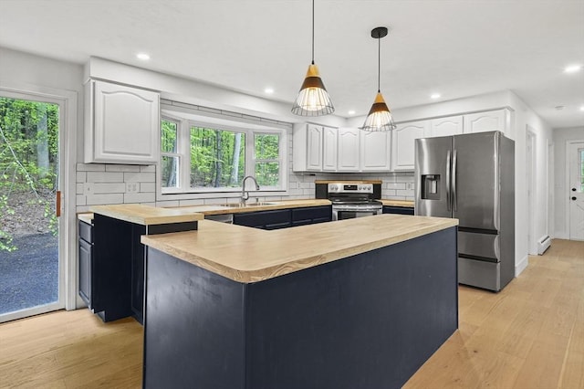 455 Main St, Rutland, MA 01543 - kitchen with stainless steel appliances, butcher block counters, white cabinets, light wood-style floors, and recessed lighting