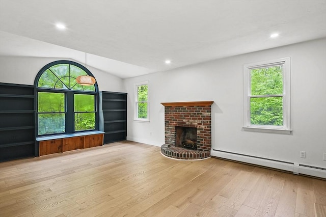 455 Main St, Rutland, MA 01543 - unfurnished living room with a baseboard radiator, wood finished floors, a brick fireplace, vaulted ceiling, and recessed lighting