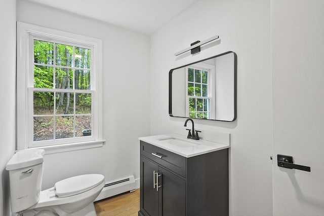 455 Main St, Rutland, MA 01543 - half bath featuring a baseboard heating unit, toilet, plenty of natural light, and vanity