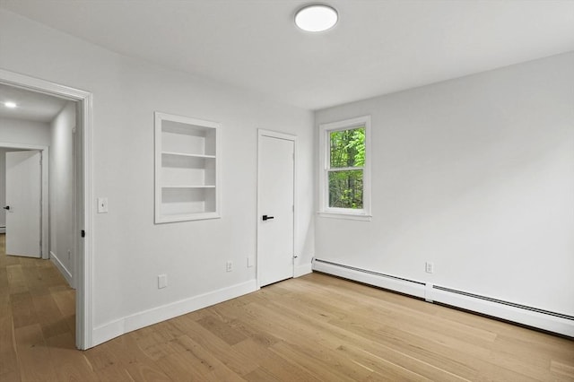 455 Main St, Rutland, MA 01543 - unfurnished bedroom with a baseboard radiator, light wood-style flooring, and baseboards