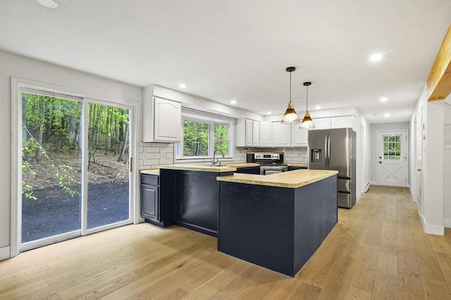 455 Main St, Rutland, MA 01543 - kitchen featuring stainless steel appliances, white cabinets, backsplash, light wood-type flooring, and recessed lighting