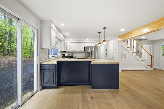 455 Main St, Rutland, MA 01543 - kitchen with appliances with stainless steel finishes, white cabinets, a peninsula, light wood finished floors, and healthy amount of natural light