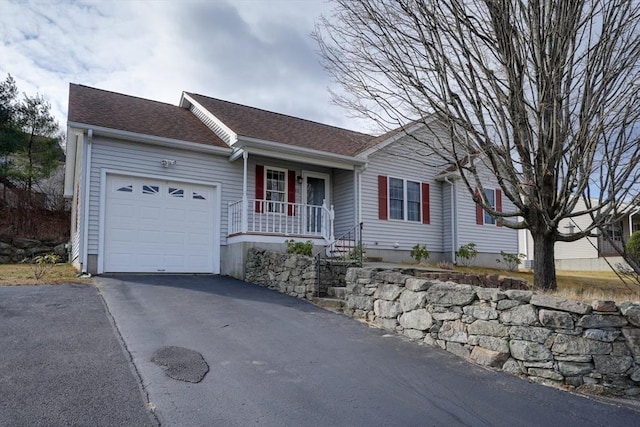 ranch-style home featuring covered porch and a garage