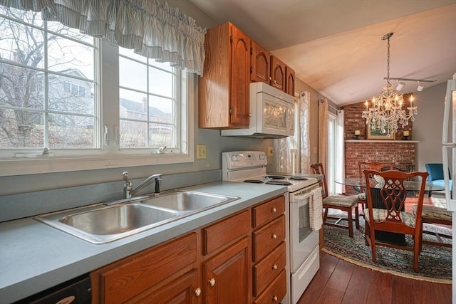 kitchen featuring a chandelier, white appliances, hanging light fixtures, and a healthy amount of sunlight