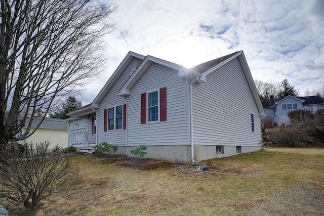 view of property exterior featuring a lawn