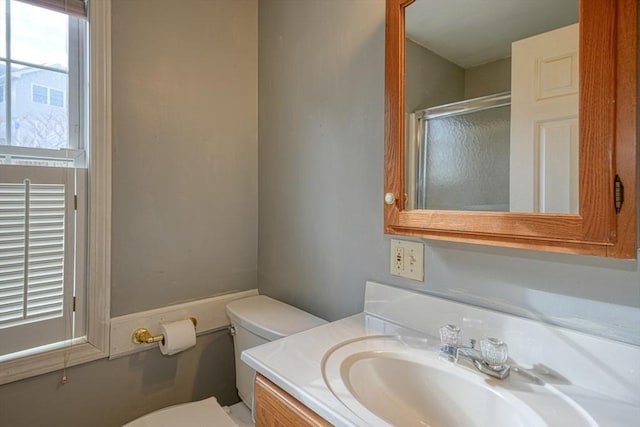 bathroom with vanity, toilet, and an enclosed shower