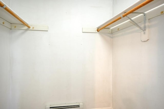 spacious closet featuring baseboard heating