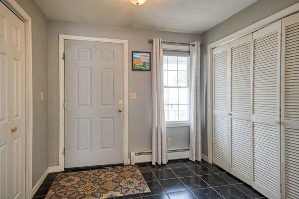 tiled foyer entrance with a wealth of natural light and a baseboard radiator