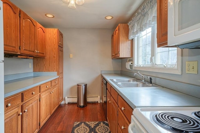 kitchen with sink, dark hardwood / wood-style floors, and a baseboard heating unit