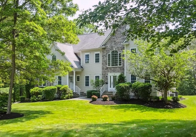 20 October Dr, Franklin, MA 02038 - back of house featuring entry steps, stone siding, and a lawn