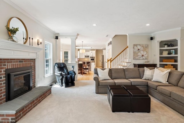 20 October Dr, Franklin, MA 02038 - living area with ornamental molding, stairway, a fireplace, recessed lighting, and decorative columns