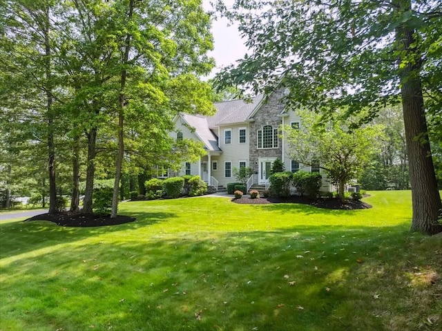 20 October Dr, Franklin, MA 02038 - back of property with stone siding and a yard