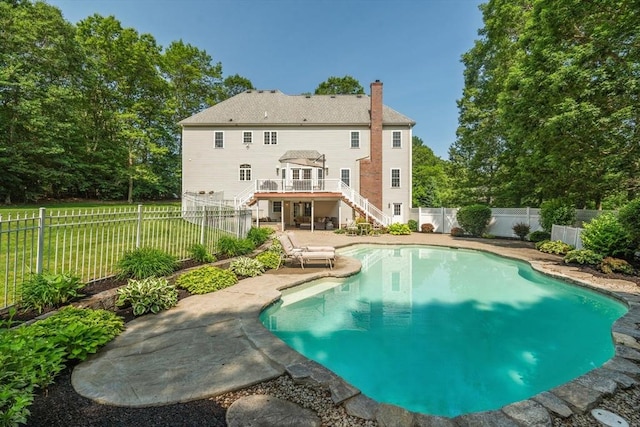 20 October Dr, Franklin, MA 02038 - rear view of house featuring stairway, a chimney, a fenced backyard, a wooden deck, and a patio
