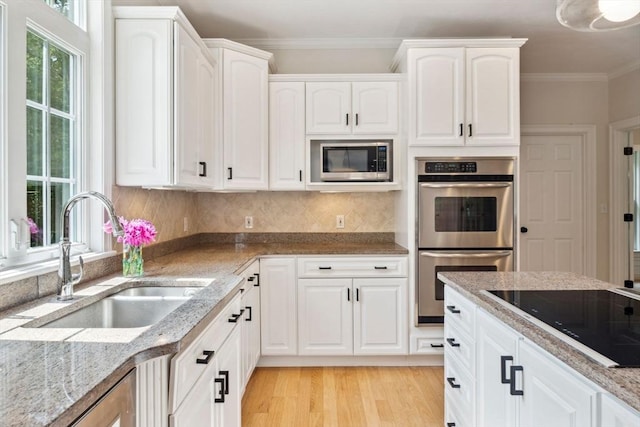 20 October Dr, Franklin, MA 02038 - kitchen with stainless steel appliances, crown molding, light stone countertops, and white cabinets