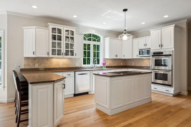 20 October Dr, Franklin, MA 02038 - kitchen featuring stainless steel appliances, dark countertops, white cabinets, crown molding, and glass insert cabinets