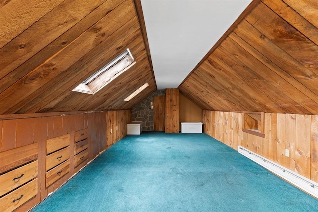 bonus room featuring a baseboard radiator, vaulted ceiling with skylight, wooden walls, and carpet