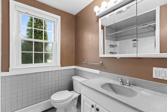 bathroom with vanity, a baseboard radiator, walk in shower, tile walls, and toilet