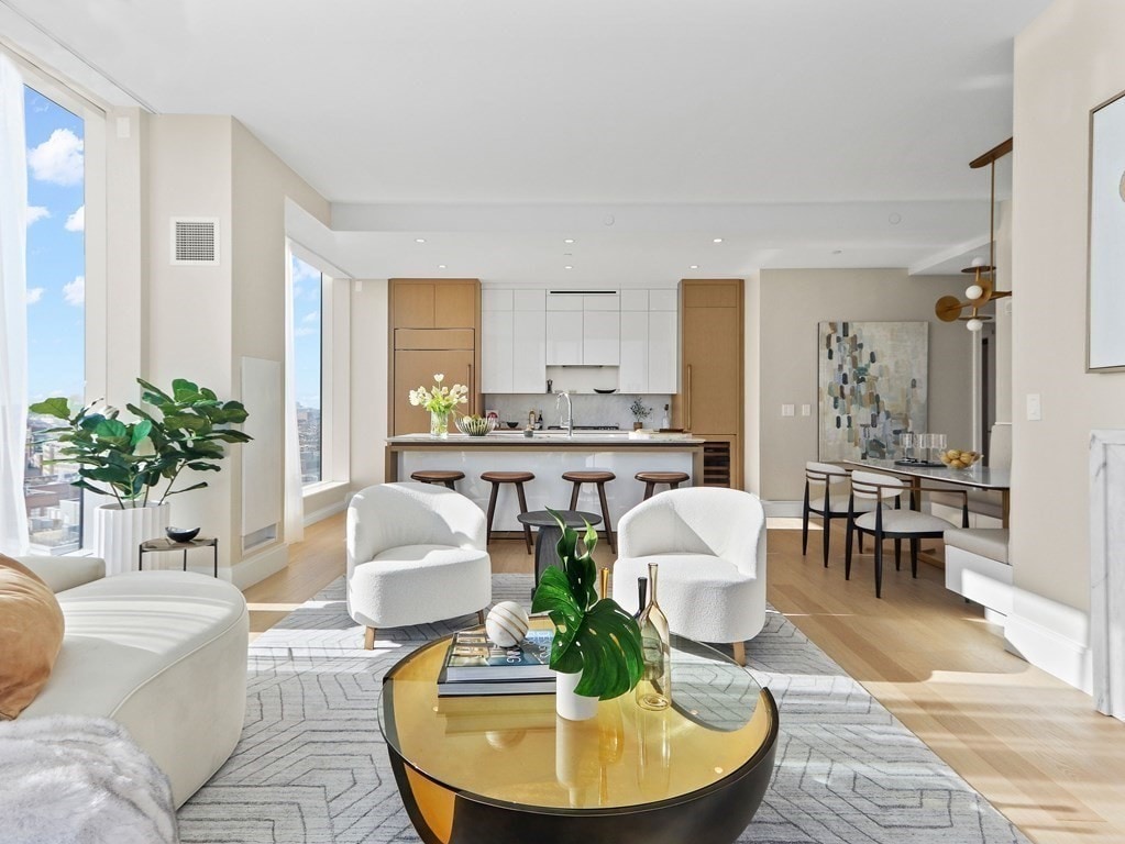 living room featuring sink and light hardwood / wood-style floors