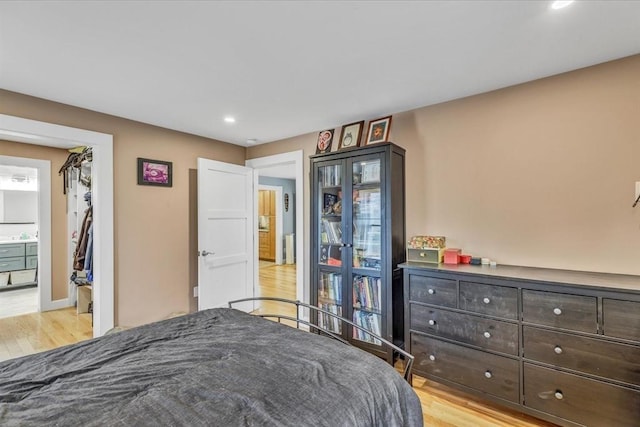 bedroom with recessed lighting, baseboards, and light wood finished floors