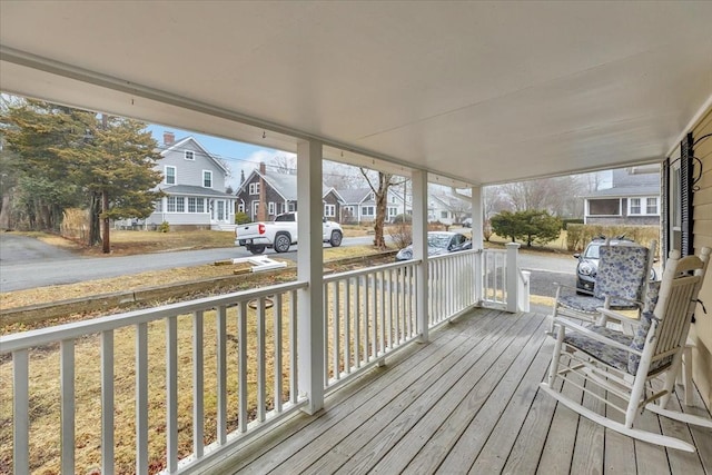 wooden deck with a residential view and a porch