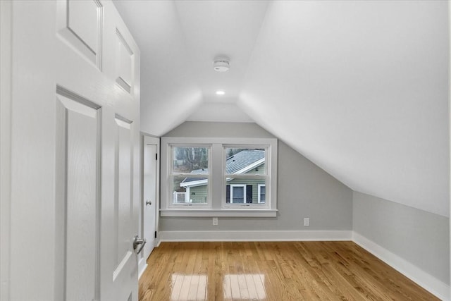 bonus room with recessed lighting, baseboards, light wood-style floors, and lofted ceiling